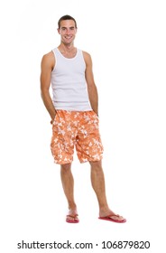 Full Length Portrait Of On Vacation Smiling Young Man In Shorts