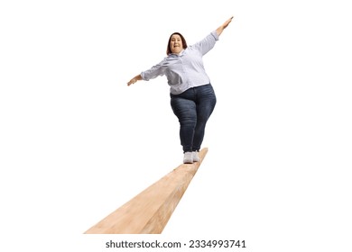 Full length portrait of an overweight woman walking on a wooden beam isolated on white background - Powered by Shutterstock