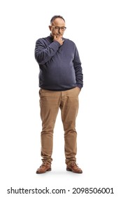 Full length portrait of a pensive mature man standing and thinking isolated on white background