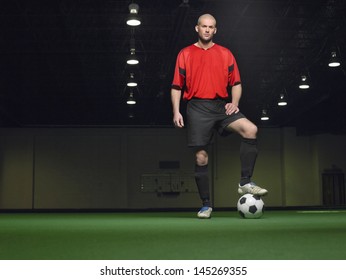 Full length portrait of a player with leg on football - Powered by Shutterstock