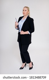 full length portrait of plus size business woman posing over gray backgound