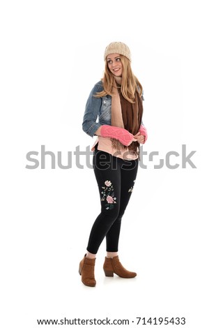 full length portrait of a pretty girl wearing girl fall fashion. standing pose on white background.