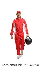 Full length portrait of a racer holding a helmet and walking towards camera isolated on white background