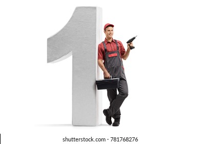 Full length portrait of a repairman holding a drill machine and a toolbox and leaning against a cardboard number one isolated on white background