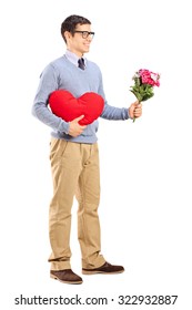 Full Length Portrait Of A Romantic Man Holding A Red Heart And A Bouquet Of Flowers Isolated On White Background