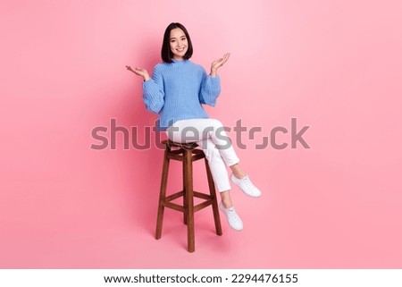 Full length portrait of satisfied cheerful lady sitting chair communicate good mood isolated on pink color background