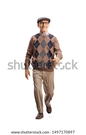 Full length portrait of a senior gentleman walking towards the camera isolated on white background