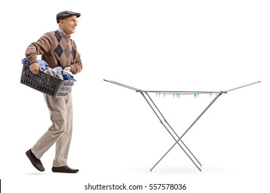 Full length portrait of a senior holding a laundry basket full of clothes and walking towards a clothing rack dryer isolated on white background - Powered by Shutterstock