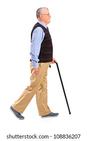 Full Length Portrait Of A Senior Man Walking With Cane Isolated On White Background