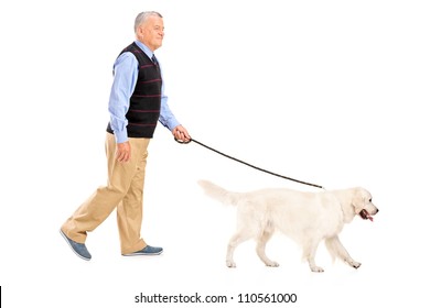 Full Length Portrait Of A Senior Man Walking A Dog, Isolated On White Background