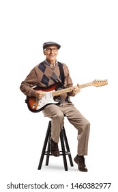 Full Length Portrait Of A Senior Man Sitting On A Chair With An Electric Guitar Isolated On White Background