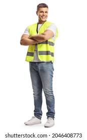 Full length portrait of a smiling security officer in a safety vest standing with crossed arms isolated on white background