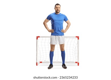 Full length portrait of a soccer player in a blue top and white shorts in front of a mini goal isolated on white background - Shutterstock ID 2365234233