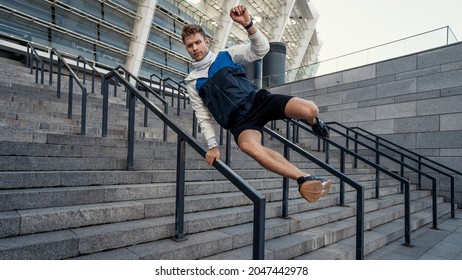 Full length portrait of sporty man jumps over the railing in the city. Sportsman running at daily outdoors training. Physical activity, motion and parkour concept - Powered by Shutterstock