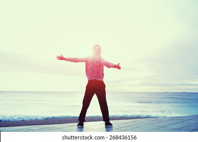 Full Length Portrait Of Sporty Man With Arms Raised Relax And Enjoying The Life Feeling Free And Happy