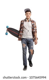 Full length portrait of a teenage skater with a longboard walking towards the camera isolated on white background