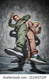 Full length portrait of two boys dancing break dance in the studio on a grunge background. Contemporary dances. Sports and active lifestyle. 