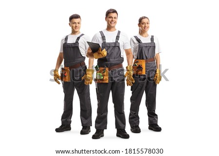Full length portrait of two male and one female workers with a tool belts isolated on white background