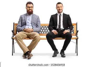 Full Length Portrait Of A Two Men Sitting On A Bench Isolated On White Background