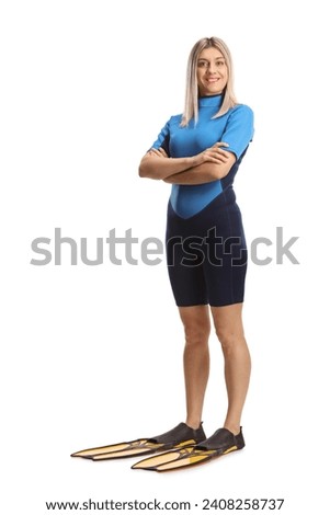 Full length portrait of a woman in a diving suit and fins isolated on white background