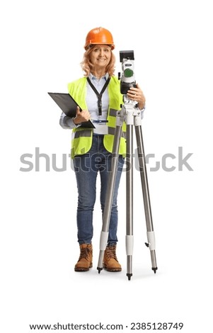 Full length portrait of a woman geodetic surveyor posing with a measuring station isolated on white background