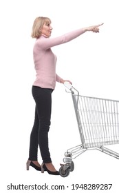 Full Length Portrait Of A Woman Pushing A Shopping Trolley