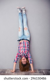 Full length portrait of a woman standing upside down