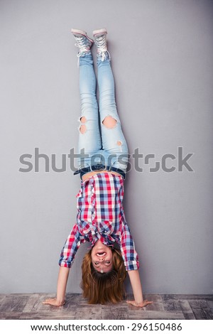 Full length portrait of a woman standing upside down