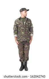 Full Length Portrait Of Young Army Soldier Standing In Attention And Looking Away Isolated On White Background