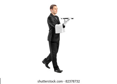 Full Length Portrait Of A Young Butler With Bow Tie Carrying A Tray Isolated On White Background