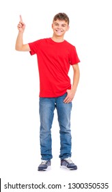 Full Length Portrait Of Young Caucasian Teen Boy Isolated On White Background. Funny Teenager Pointing Finger Up. Handsome Child Looking At Camera And Smiling.