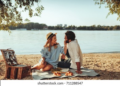 Full length portrait of young couple having good times on a picnic date. - Powered by Shutterstock