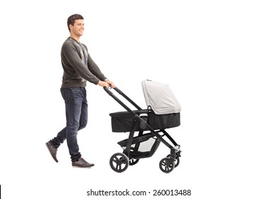 Full Length Portrait Of A Young Father Pushing A Baby Stroller Isolated On White Background