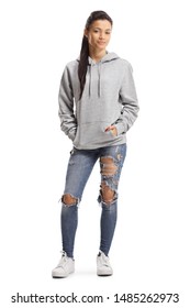 Full Length Portrait Of A Young Female With Ripped Jeans And A Hoodie Posing Isolated On White Background