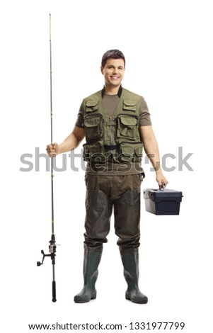 Full length portrait of a young fisherman posing with a fishing rod and a case isolated on white background