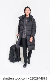 Full Length Portrait Of Young Handsome Man In Winter Warm Clothing With, Holding Hand Luggage On Isolated White Background

