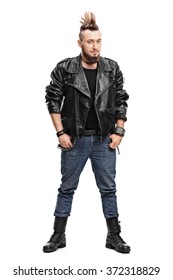 Full length portrait of a young male punk in a black leather jacket and black boots isolated on white background