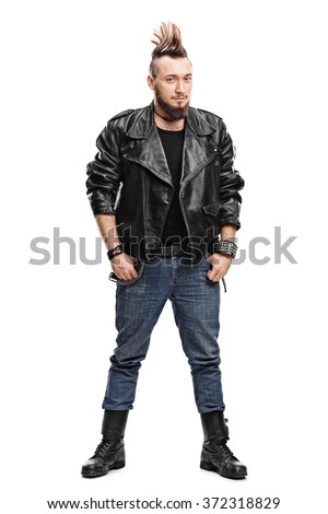 Full length portrait of a young male punk in a black leather jacket and black boots isolated on white background