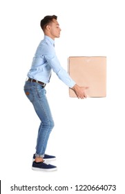 Full Length Portrait Of Young Man Lifting Heavy Cardboard Box On White Background. Posture Concept