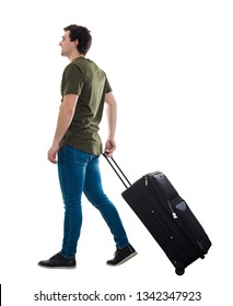 Full length portrait of young man traveler carrying his rolling suitcase. Man passenger waiting taxi for travel to airport isolated over white background.