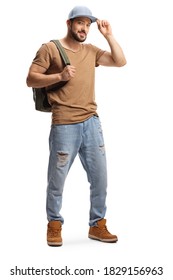 Full Length Portrait Of A Young Man With A Backpack And Ripped Jeans Holding His Cap Isolated On White Background