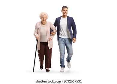 Full length portrait of a young man helping an elderly lady with a walking cane isolated on white background