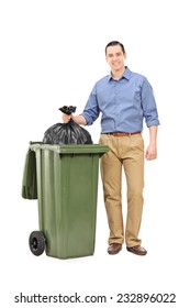 Full Length Portrait Of A Young Man Throwing Out The Garbage Isolated On White Background