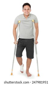 Full Length Portrait Of Young Man With Broken Leg Use Crutches