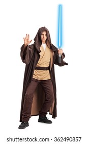 Full length portrait of a young man with a brown hooded cape and a laser sword isolated on white background