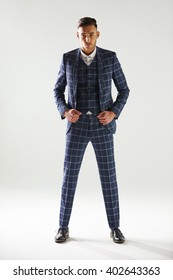 Full Length Portrait Of Young Man Wearing Checked Suit