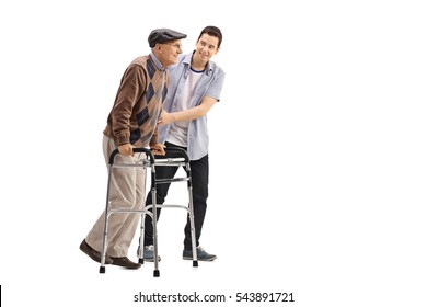 Full length portrait of a young man helping an elderly man with a walker isolated on white background