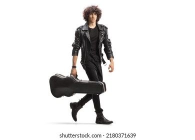 Full length portrait of a young rock musician carrying a guitar in a black case isolated on white background - Powered by Shutterstock