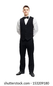 Full Length Portrait Of Young Smiling Waiter Standing With Hands Behind His Back Isolated On White Background