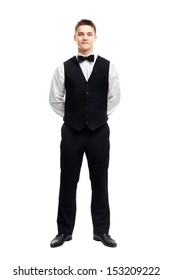 Full Length Portrait Of Young Smiling Waiter Standing With Hands Behind His Back Isolated On White Background